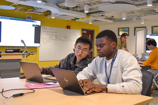 Two students working on laptops